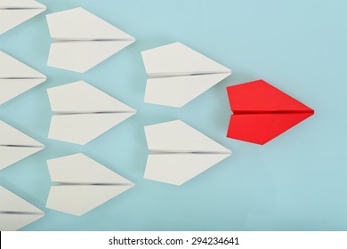 red paper plane leading white ones, leadership concept