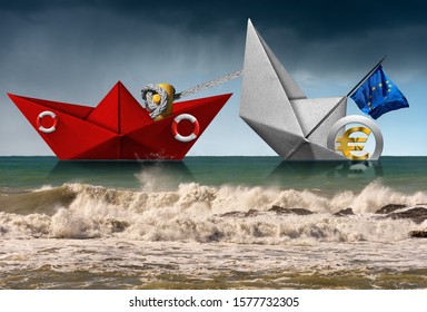 Red Paper Rescue Boat Of The Coast Guard Towing A Paper Boat, With The European Union Flag, And Euro Currency Symbol, In A Rough Sea With Waves And Sky With Rain. Recession Concept