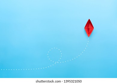 Red paper ship on blue background, business successful journey concept. copy space - Shutterstock ID 1395321050