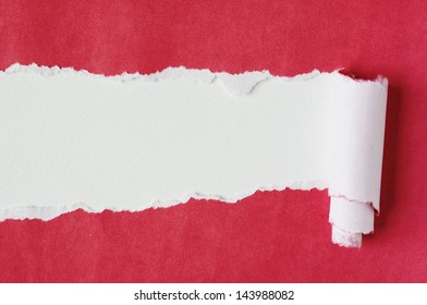 Red paper torn on white background.