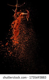 Red Paprika Spices Powder Explosion, Flying Chili Pepper Isolated On Black Background. Splash Of Spice Background. 