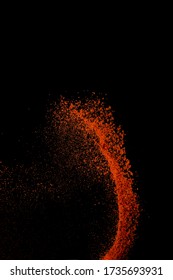 Red Paprika Spices Powder Explosion, Flying Chili Pepper Isolated On Black Background. Splash Of Spice Background. 