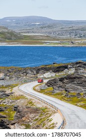 A Red Parcel Delivery Van On Curvy Road In Northern Norway In Summer