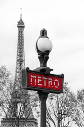Red Paris Metro Subway Entry Sign With Eiffel Tower In The Background, Paris, France 