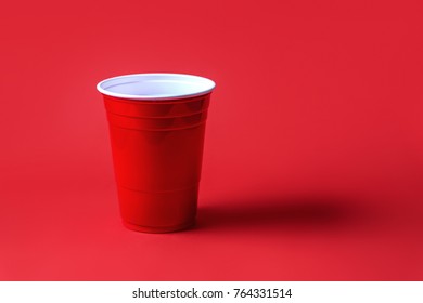 Red Party Cup On Red Background. Beer Pong Tournament Or College Celebration Concept.