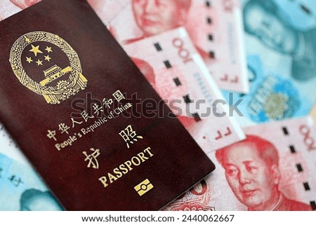 Red passport of People Republic of China and chinese yuan money bills. PRC chinese passport on bright background close up 商業照片 © 