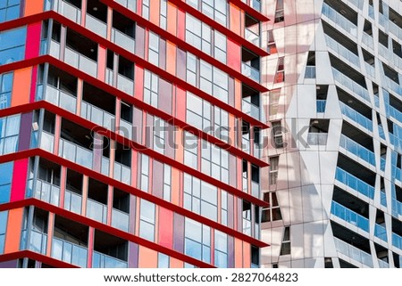Red patterns of the Calypso building create geometric patterns in Rotterdam, Netherlands