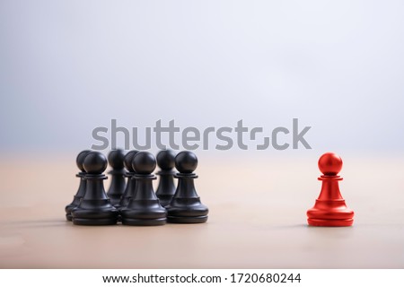 Red pawn chess stepped out of group to show different thinking ideas and leadership. Business technology change and disruption for new normal concept.