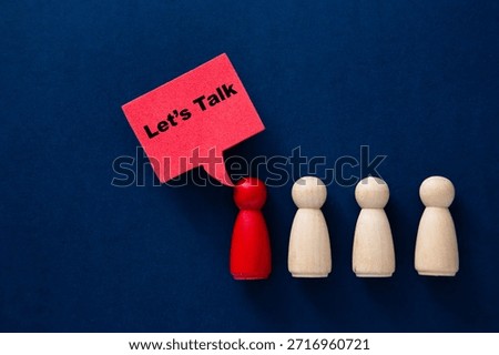 Red peg doll with a speech bubble saying let's talk addressing plain peg dolls
