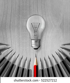 Red Pencil Light Bulb In The Middle Of The Black And White Pencil. The Concept Of Energy