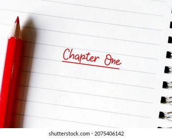 Red pencil on notebook with text written CHAPTER ONE, concept of first time book writing, author start his novel, forst chapter creative writing