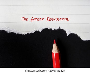 Red pencil on torn note with text written THE GREAT RESIGNATION, means the Big Quit, ongoing trend of millions employees voluntarily leaving their jobs in response to COVID-19 or for work life balance