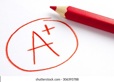 Red Pencil And A Plus Grade Mark 