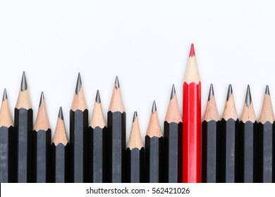 Red pencil standing out from crowd of plenty identical black fellows on white background. Leadership, uniqueness, independence, initiative, strategy, dissent, think different, business success concept - Shutterstock ID 562421026