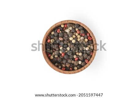 Red pepper and black papper on wooden bowl on white background. Isolated papper. Top view