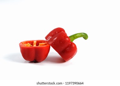 Red Pepper Cut In Half Isolated On White With Clipping Path.