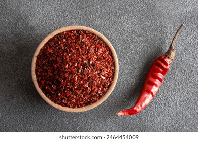 Red pepper flakes.Red chili peppers in wooden bowl on black background.Dried chili peppers - Powered by Shutterstock