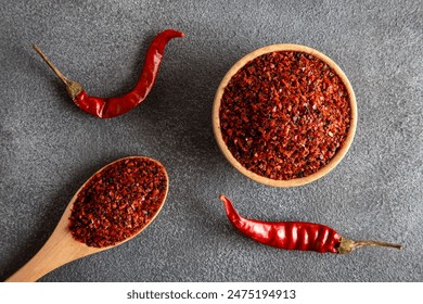 Red pepper flakes.Red chili peppers in wooden bowl on black background.Dried chili peppers - Powered by Shutterstock