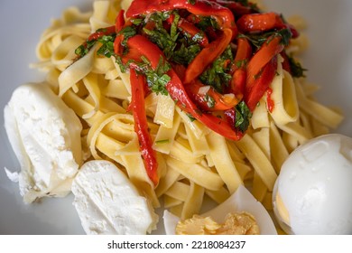 Red Pepper Pasta With Cheese And Eggs Served On The Plate