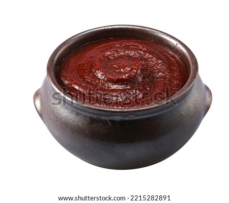 Red pepper paste in a jar on a white background