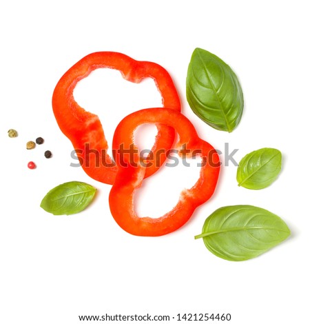 red pepper slices with basil leaves isolated on white background cutout. Top view, flat lay.