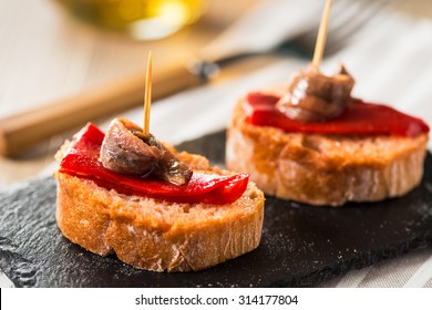 Red peppers with great anchovies on a slice of bread. Typical spanish food.