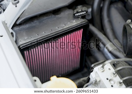 Red performance air filter enhances engine horsepower and fuel efficiency