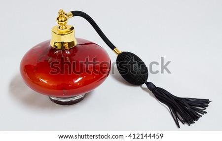 Red perfume spray bottle with tassle
