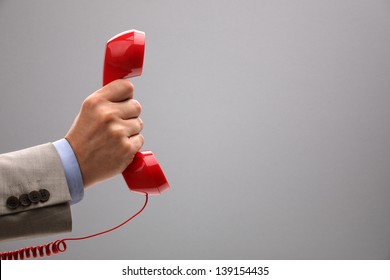 Red Phone Over Gray Background Concept For Customer Support Line Or Important Call