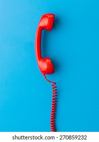 Red Phone Receiver On Blue Background