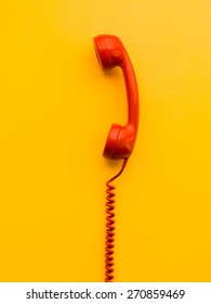 Red Phone Receiver On Yellow Background