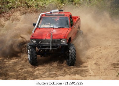 Red Pickup Off Road  4WD Spin Mud Dirty Track On Mountain Hill.                               