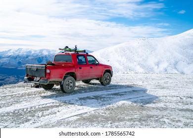 Red Pickup Truck On Road, Beautiful Winter Road Under Snow Mountains New Zealand.