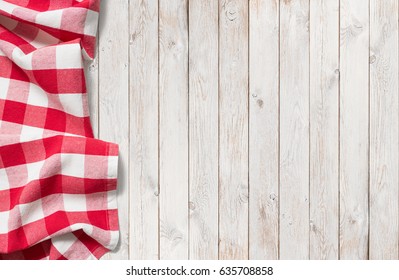 red picnic cloth on white wood table