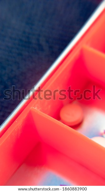 Red
pill box compartments filled with different
pills