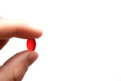 Red Pill Capsule Holding In Hand.