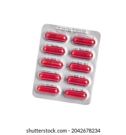 Red pills in a blister pack isolated on white background