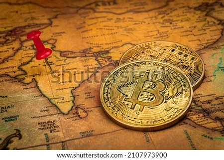 Red pin and bitcoin on India world map Investment in cryptocurrency concept