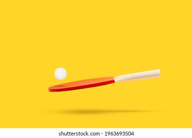 Red Ping Pong Paddle And A White Ball Floating On A Yellow Background With Copy Space