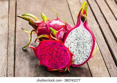 Red And Pink Dragonfruit On Wooden Vintage Background