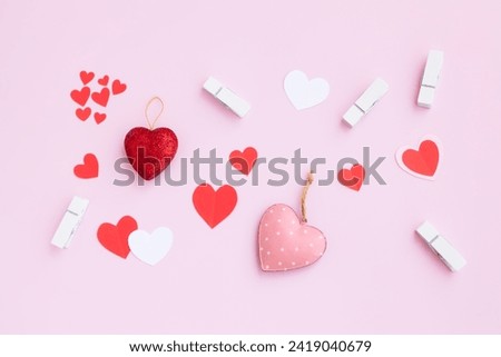 Red and pink heart with white wooden clothespin on pink background, Steel heart, Glitter heart and paper heart, Love and valentine concept.