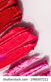 Red And Pink Lipstick Swash With Water Drops Closeup. Make-up Cosmetic Products Color Sample Isolated. Beauty Swash Texture. Vertical Banner Template