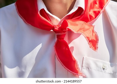 Red pioneer tie on the neck of the teenager as a symbol of socialism