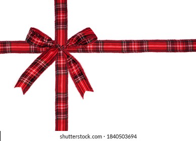 Red Plaid Christmas Gift Bow And Ribbon Arranged As Wrapped Gift Box Isolated On A White Background