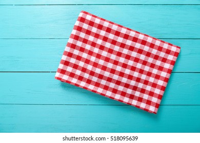 Red Plaid Tablecloth On Blue Wooden Table. Top View And Copy Space. Mock Up