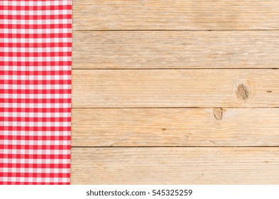 Red Plaid Tablecloth On Rustic Wooden Table, Top View And Copy Space.