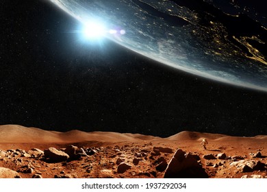 Red planet Mars with stars and planet Earth, journey space concept. Space man astronaut walks through the red desert with mountains overlooking space.