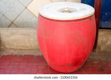 A Red Plastic Barrel As A Traditional Water Storage Container From Indonesia. 