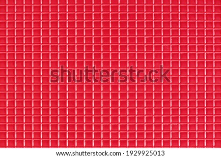 Red plastic checkered pattern texture. Flat lay top view.