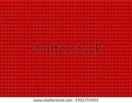Red plastic constructor background. Pattern. Toys
